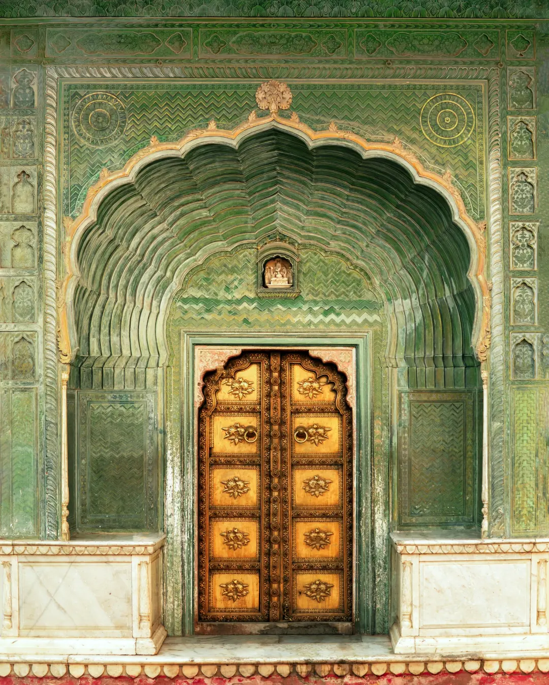 Carved green doorway in a Rajasthan palace